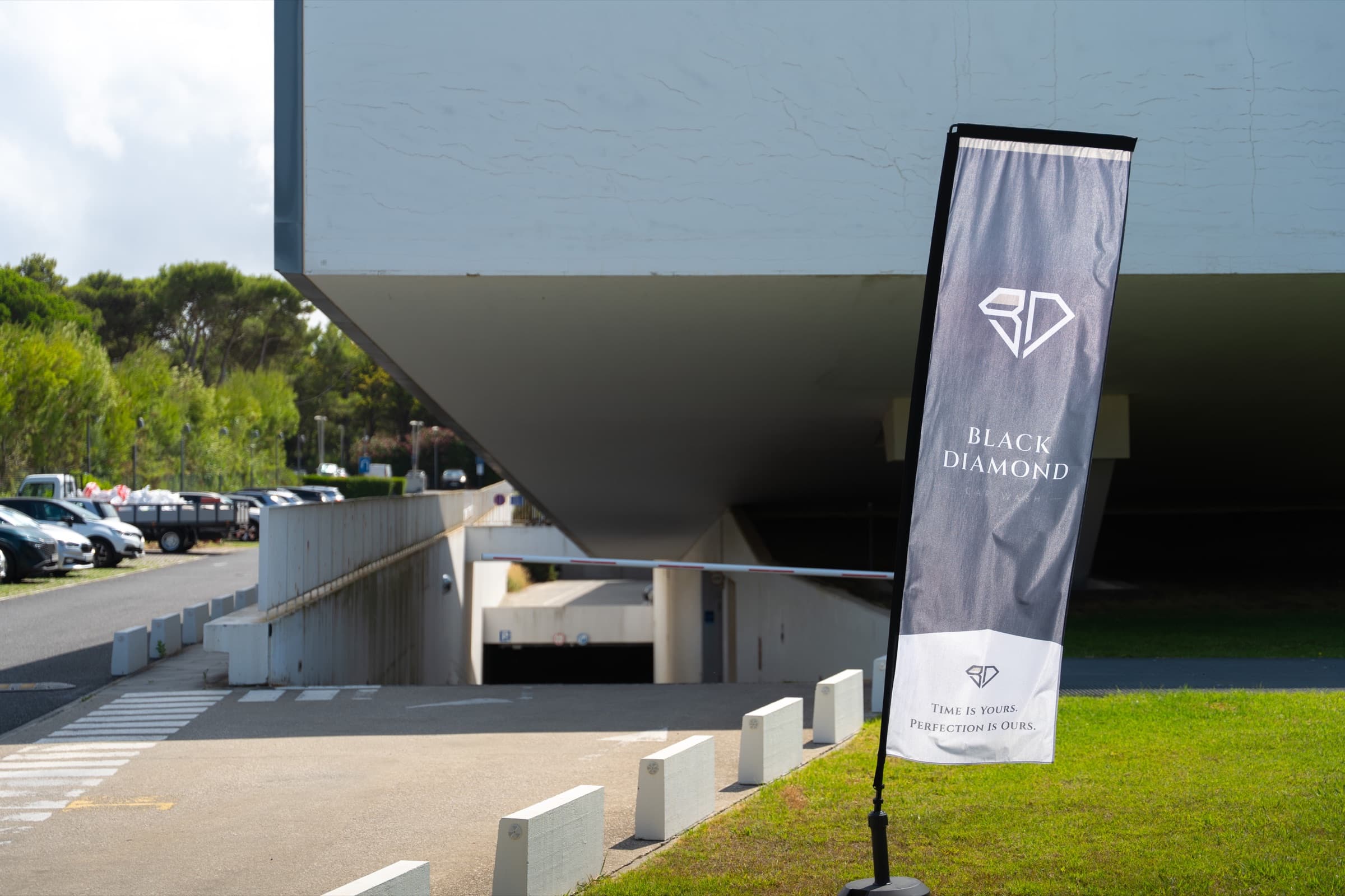 Black Diamond feather flag at the LACS driveway with the Time is Yours slogan